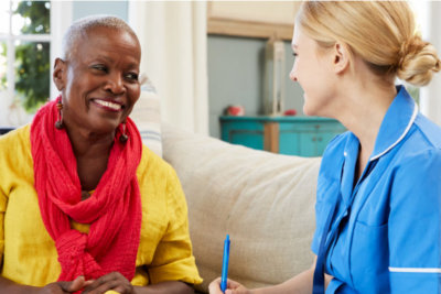 caregiver having a conversation with the senior woman smiling